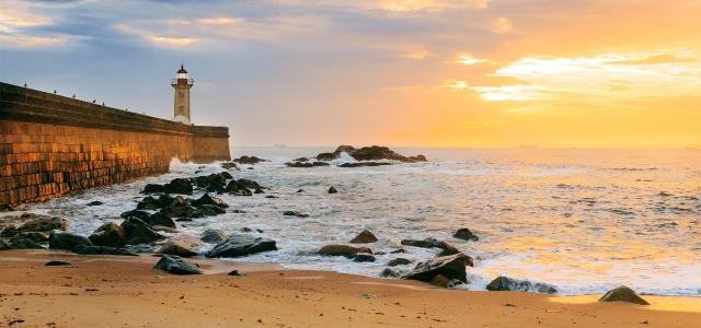 Lighthouse on Beach at Sunset